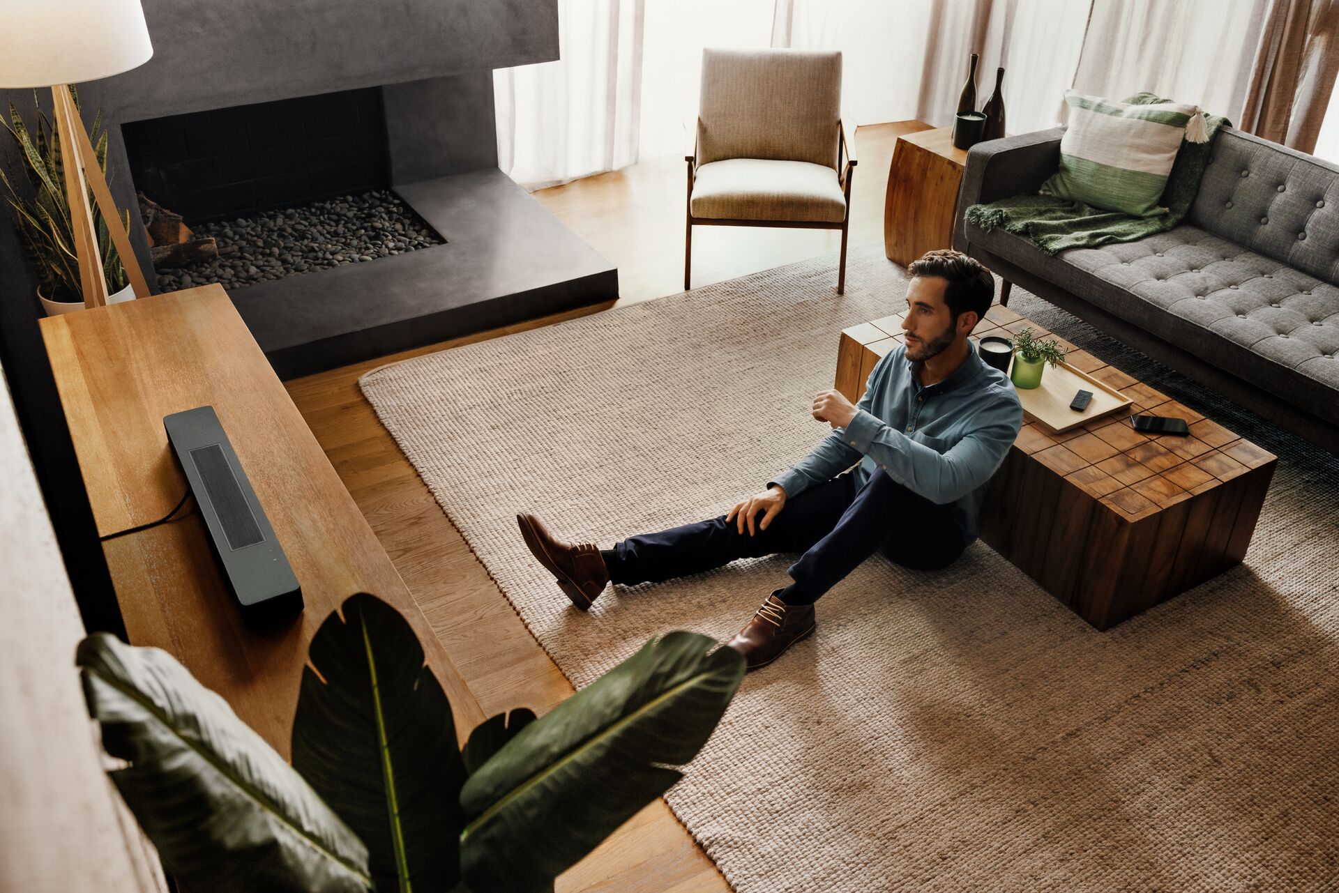 Man listening to Bose smart soundbar 600